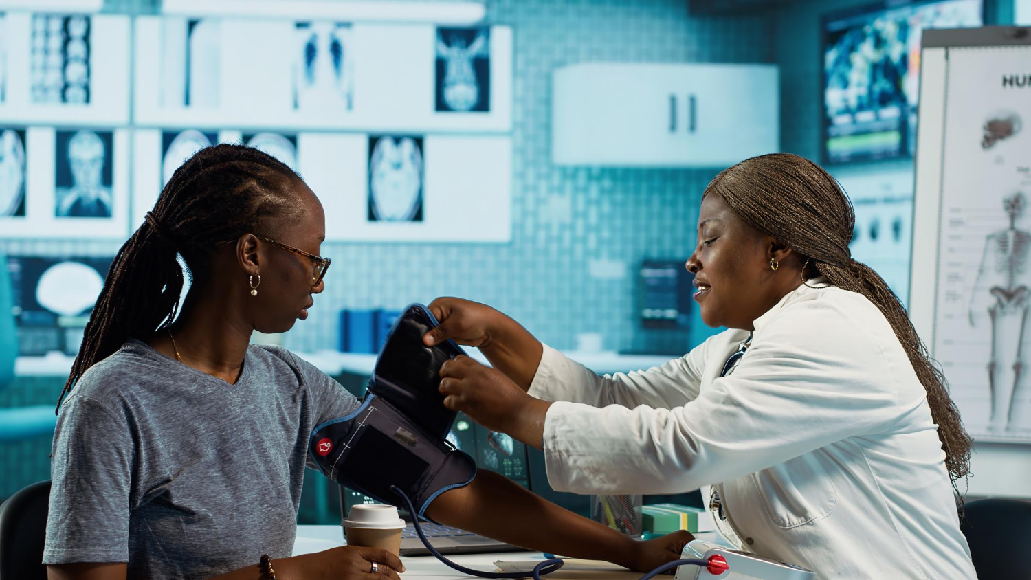 A female doctor about to check a person's blood pressure